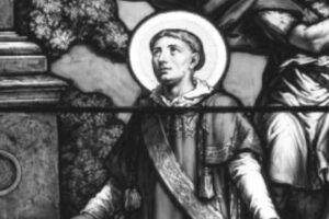 św. Baudeliusz z Nîmes Św. Baudeliusz z Nîmes w czarno-białym przedstawieniu witrażowym, ukazany z aureolą i rozłożonymi rękami.
